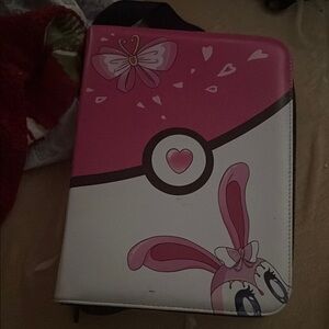 Pink and White Pokémon book to put the cards